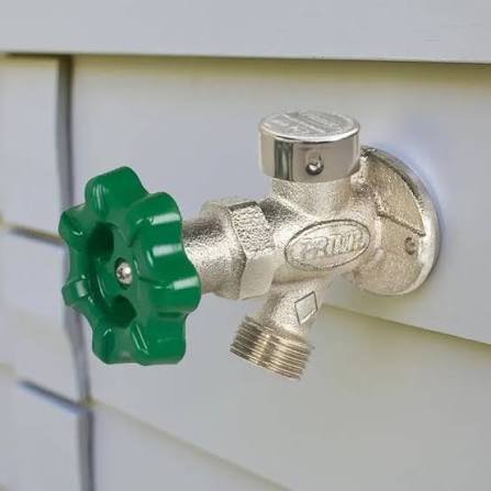 Frost-free outside hose bibb with green handle installed on home siding