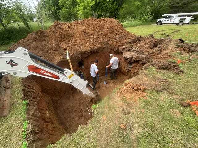 Titan Plumbing crew and excavator preparing an aerobic septic system installation near Durant Oklahoma