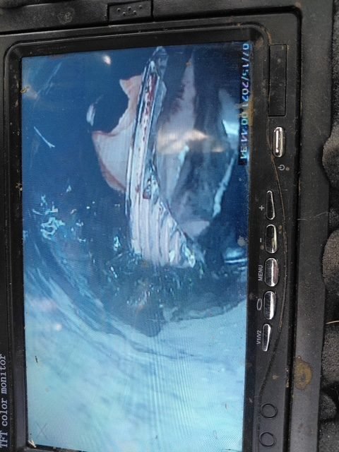 Drain inspection monitor showing a broken cleanout plug lodged inside the pipe.