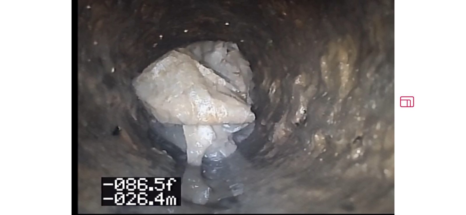 Sewer camera view showing baby wipes clogging the drain line.