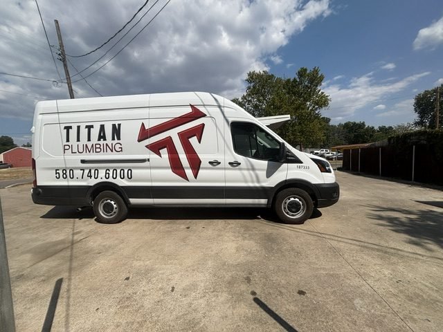 Titan Plumbing service van displaying the company logo and phone number, 580-740-6000.